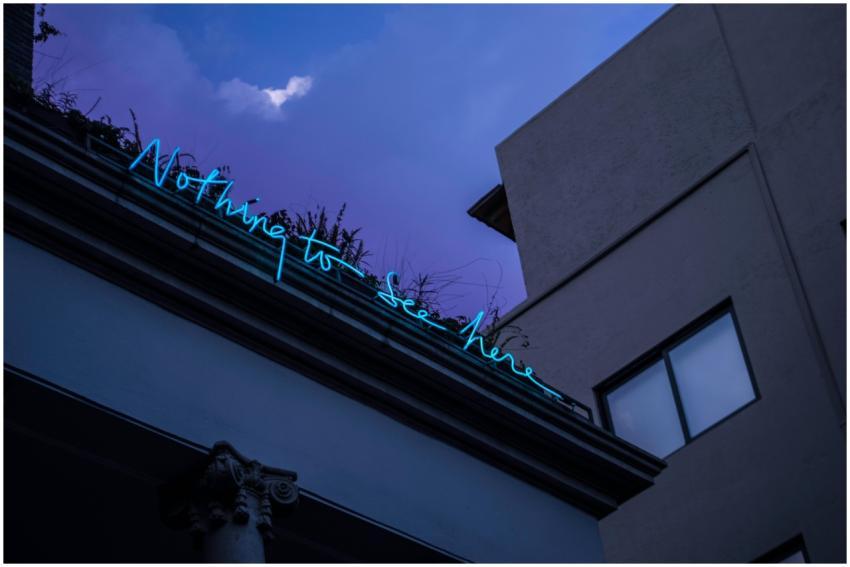 Low-angle shot of a neon sign reading 'Nothing to