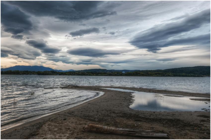Peaceful lake with dramatic clouds and reflection