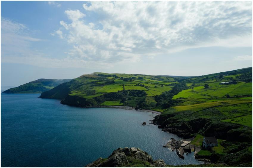 Idyllic view of a lush green coastline meeting the