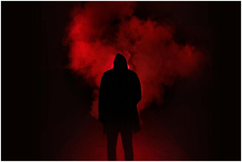 A mysterious silhouette standing against a backdro