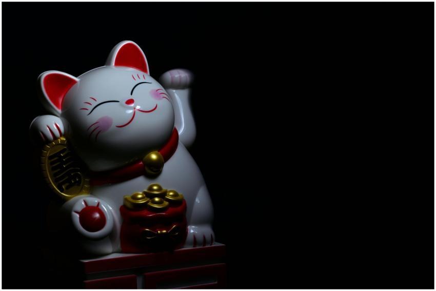 A ceramic Maneki Neko, or lucky cat, figurine symb