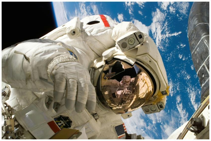 Astronaut floating in space during a spacewalk, vi