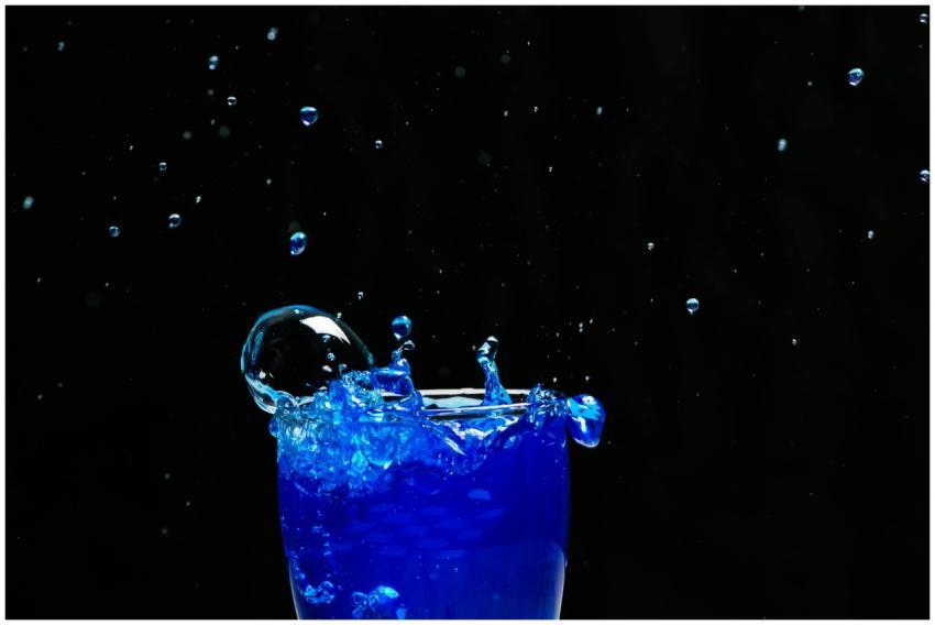 A captivating splash of bright blue liquid against