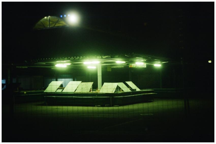 A city market stall glowing with green lighting, c