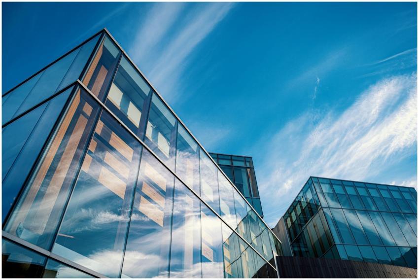 Low angle view of contemporary glass office buildi