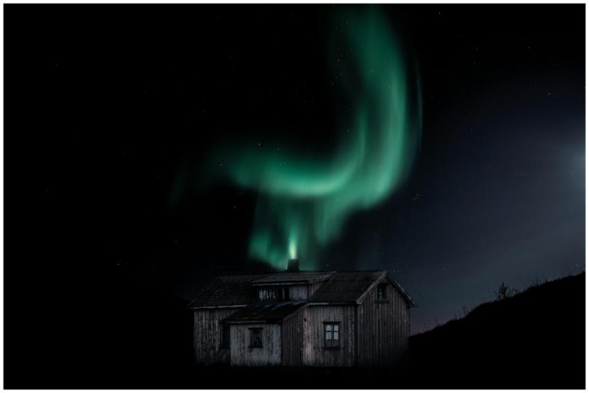 Vibrant aurora borealis dancing over a rustic wood