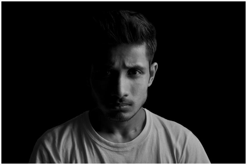 Dramatic black and white portrait of a young man w
