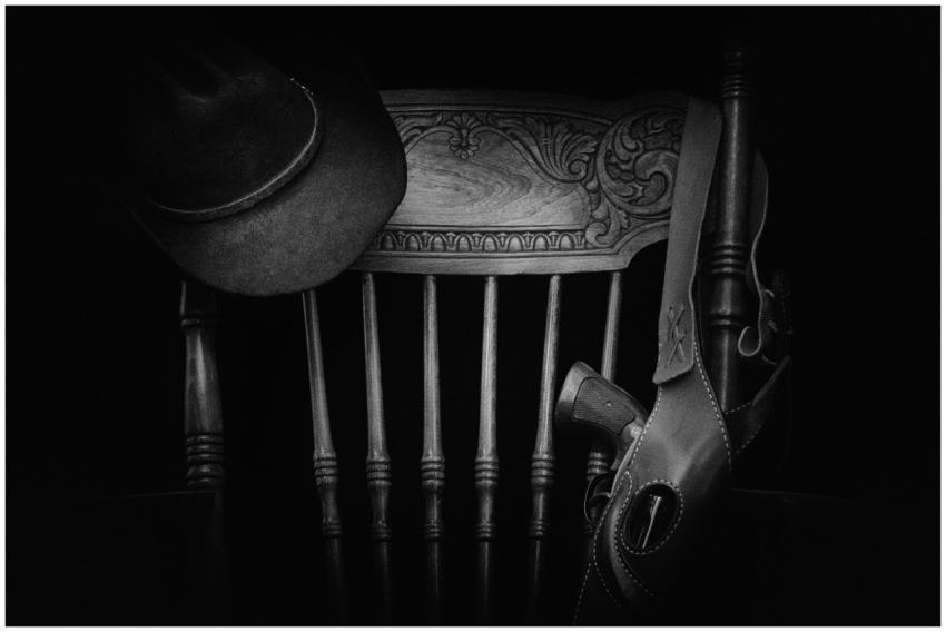 A classic western-themed black and white still lif