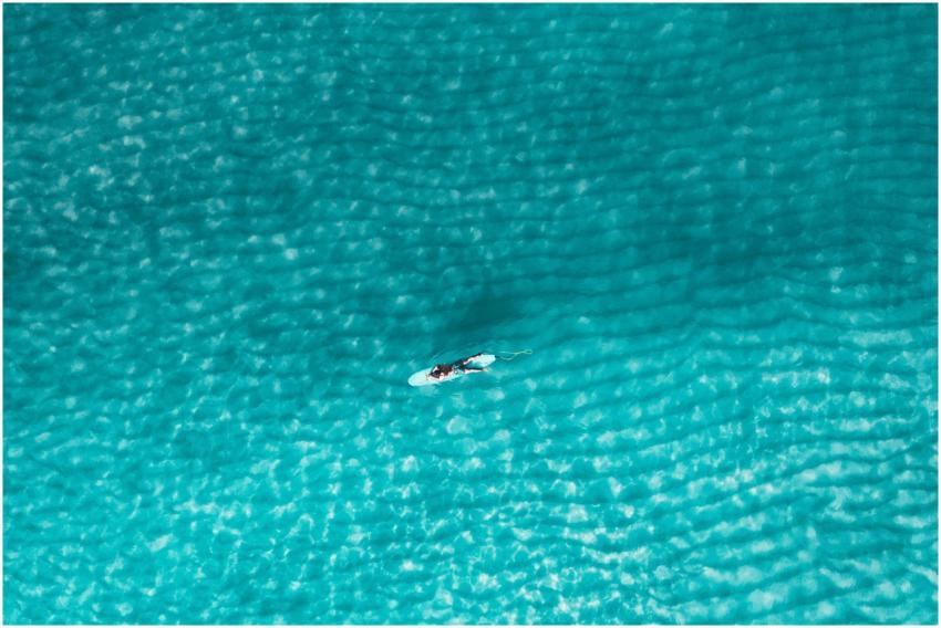 Aerial shot of a lone surfer on a surfboard in cry