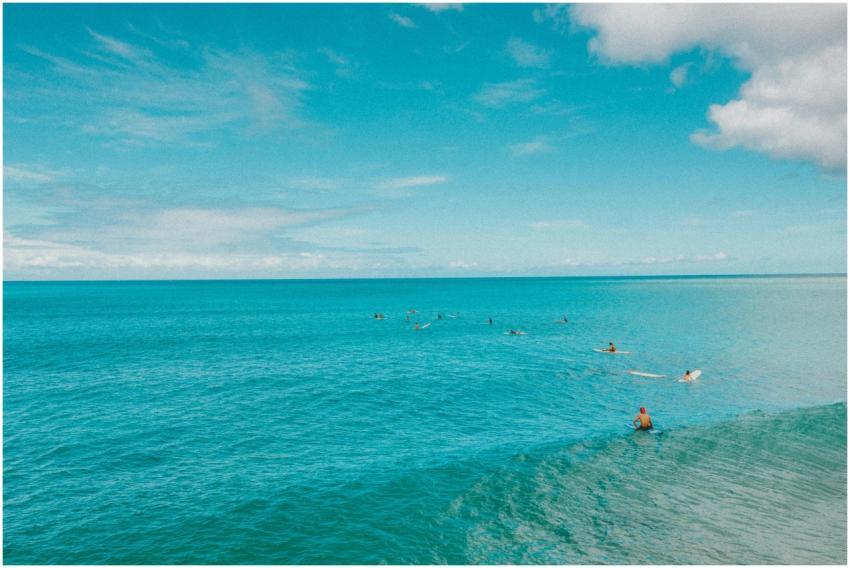 Aerial shot of surfers enjoying the crystal-clear