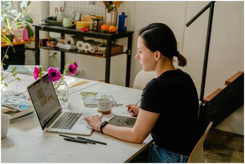 Woman working from home with a laptop and tablet i