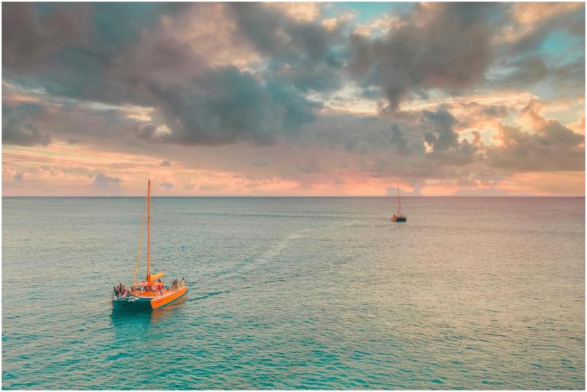 Sailboats cruising during a vibrant sunset, captur