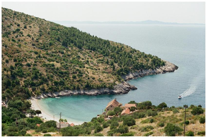 A picturesque coastal cove with a lush hillside an