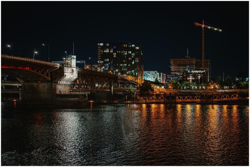 Illuminated urban night scene featuring a bridge r