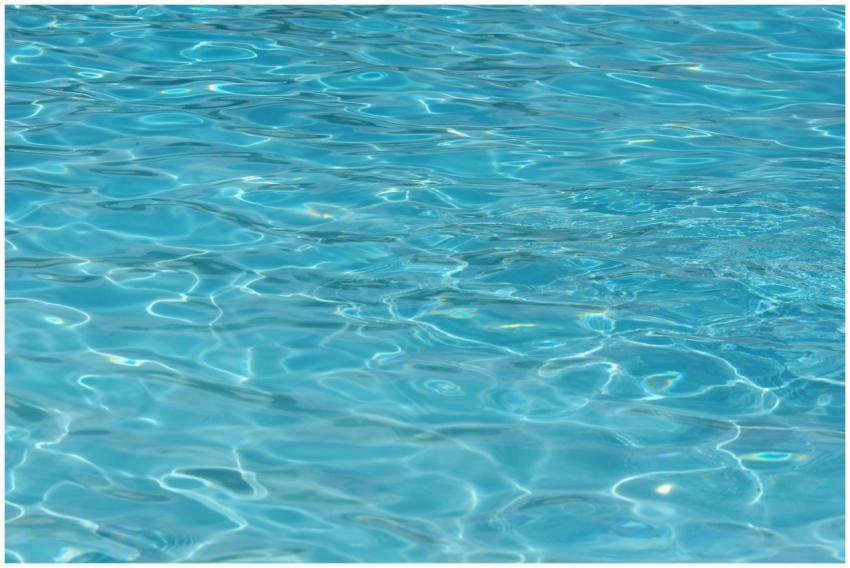 A vibrant turquoise water surface, showcasing clea