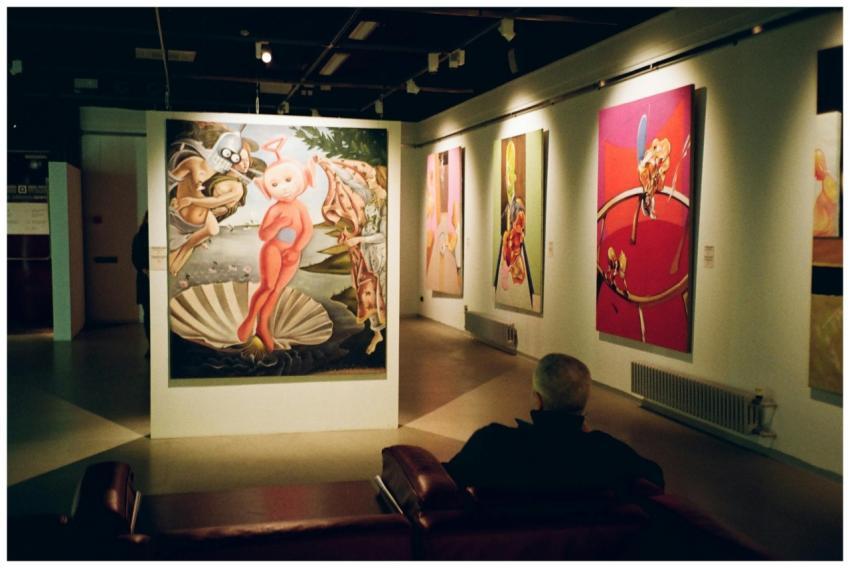 Person seated in a contemporary art museum observi