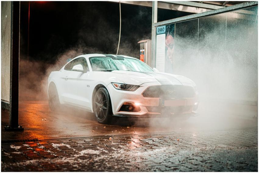 White Ford Mustang in a misty carwash setting, ill