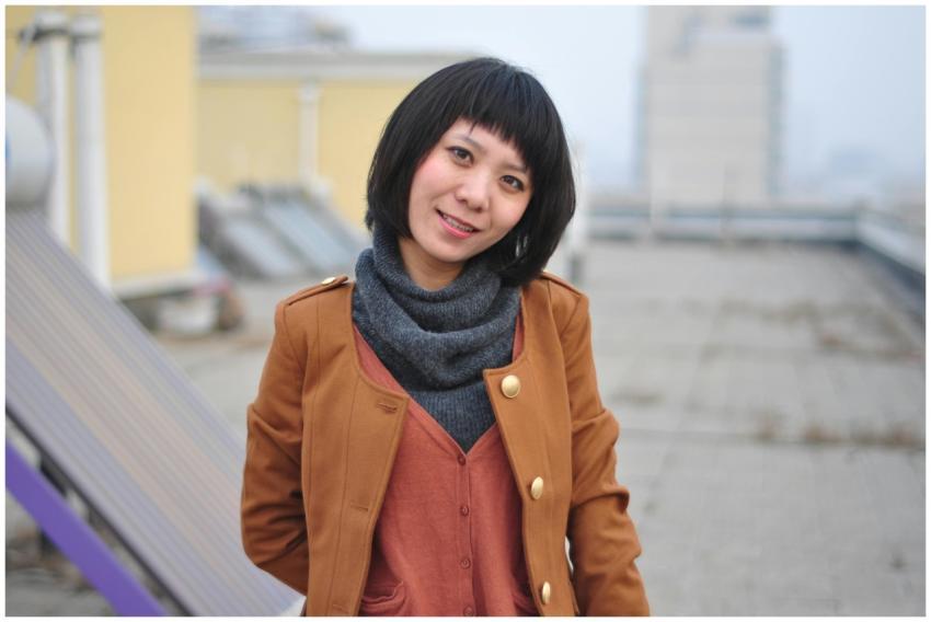 Portrait of a smiling woman wearing a brown coat a