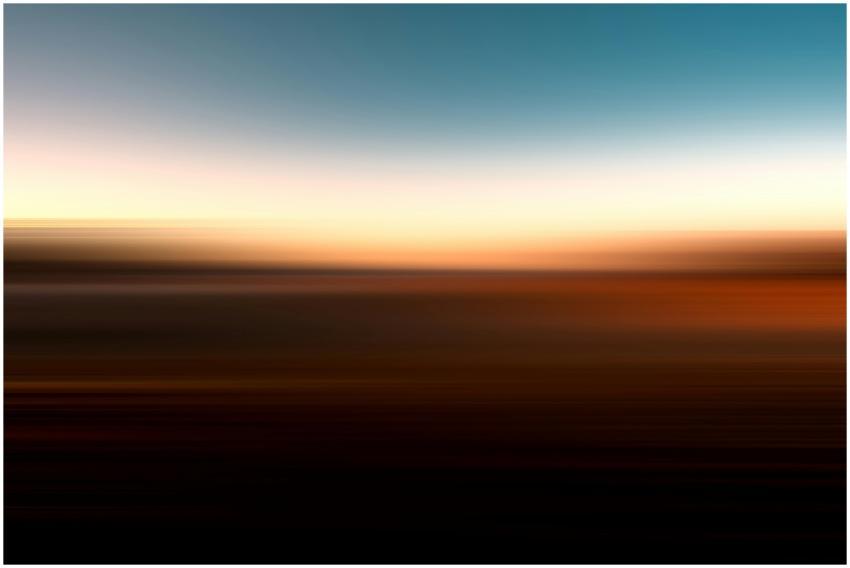 Abstract image of a blurred ocean horizon with sun