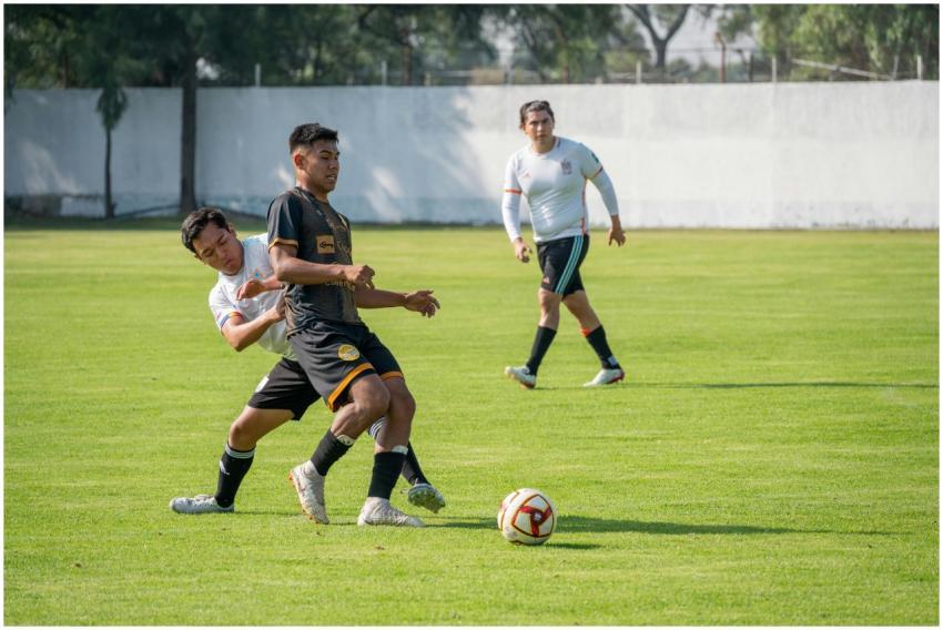Players in an intense football match, showcasing t
