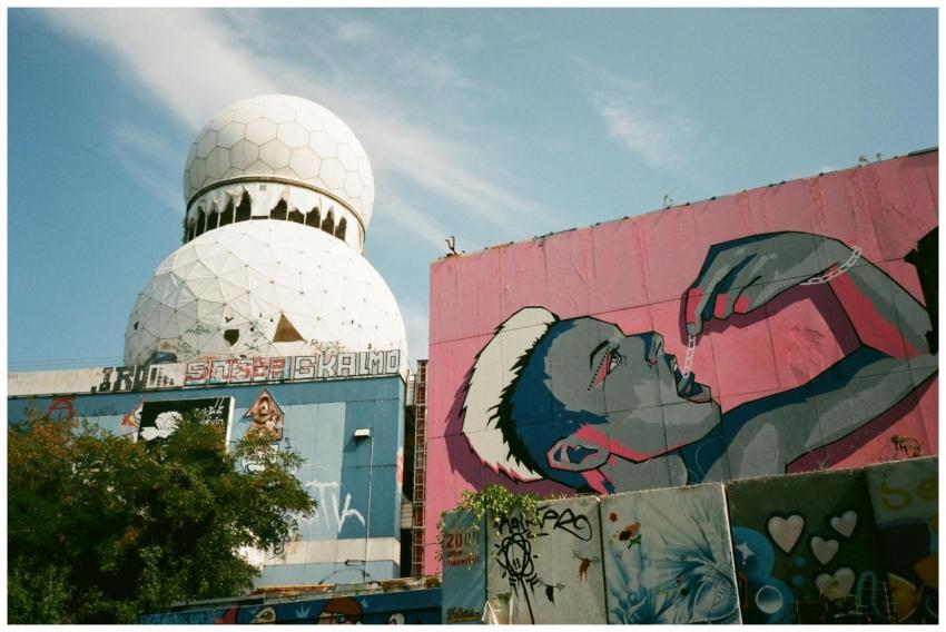 Bright urban graffiti art adorns a building next t