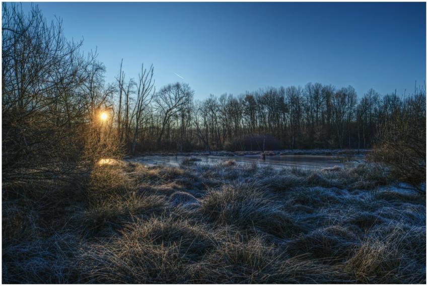 Beautiful sunrise over a frosty winter landscape w