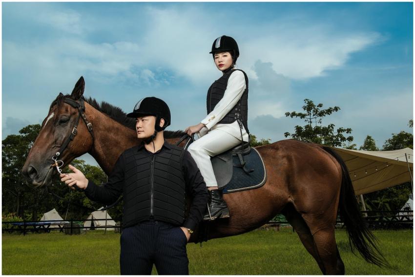 Professional equestrian holding a horse with a rid