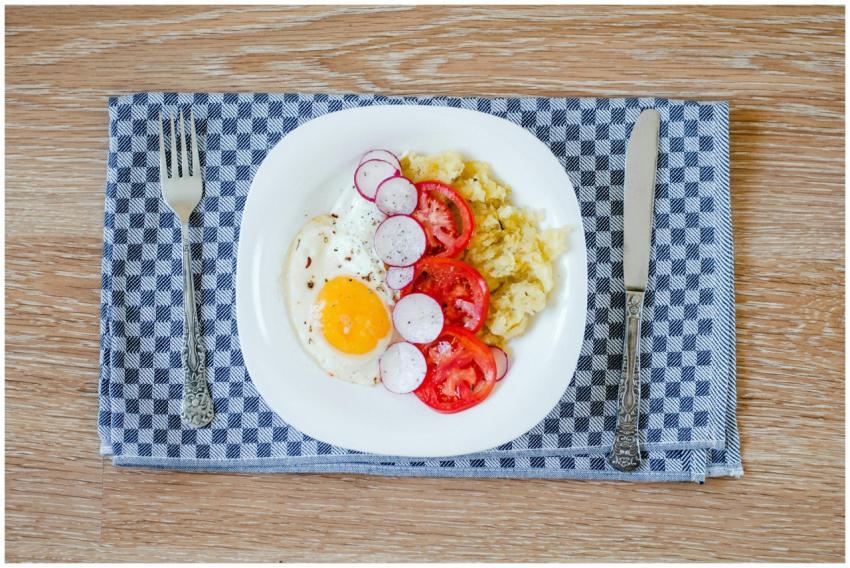 A delicious breakfast featuring fried eggs, tomato