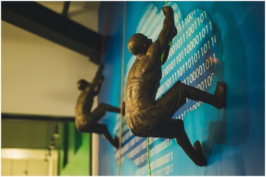 Sculptures of climbers in a modern art exhibition,