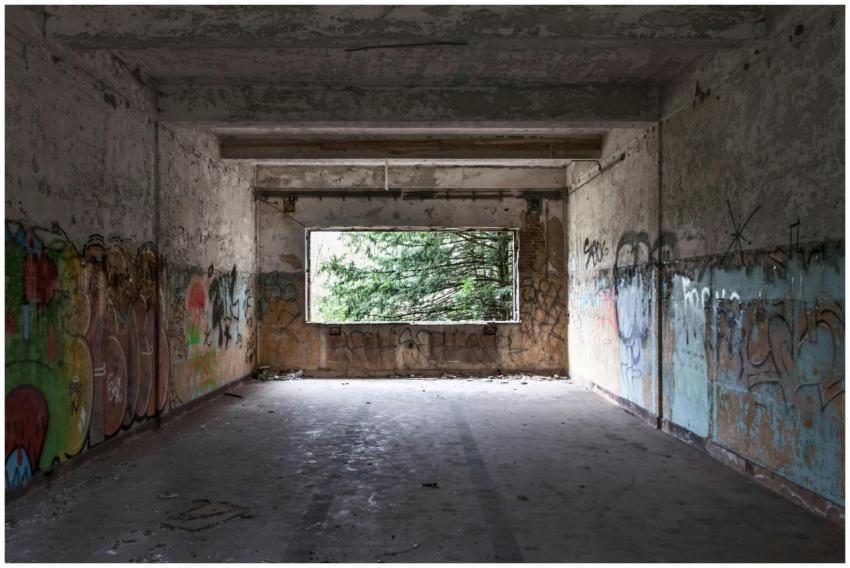 Interior view of an abandoned building with graffi
