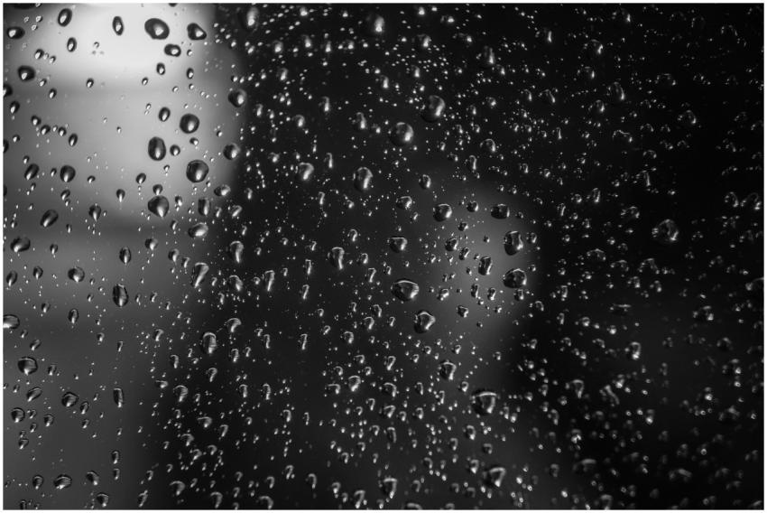 A mesmerizing macro shot of raindrops on glass, ca