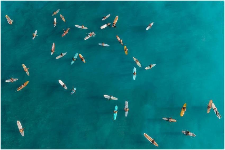 Drone captures surfers waiting on their boards in