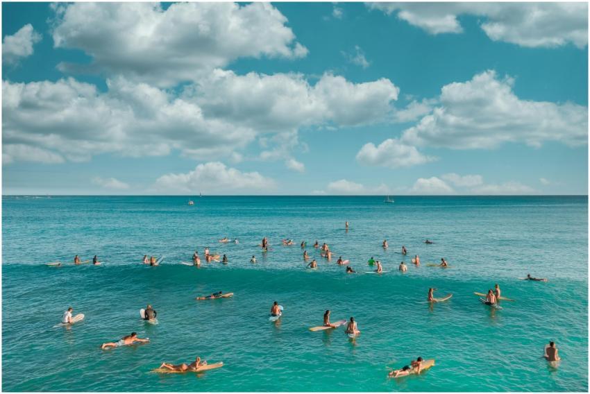 Surfers enjoying the clear waters and waves in Haw
