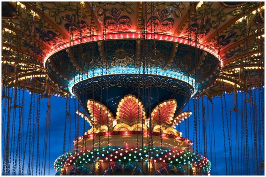 Vibrant lights illuminate a carousel at twilight i
