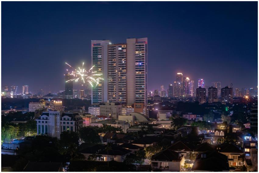 Vibrant fireworks over the Jakarta skyline at nigh