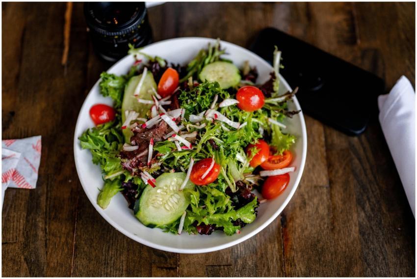 A vibrant fresh salad with greens, cherry tomatoes