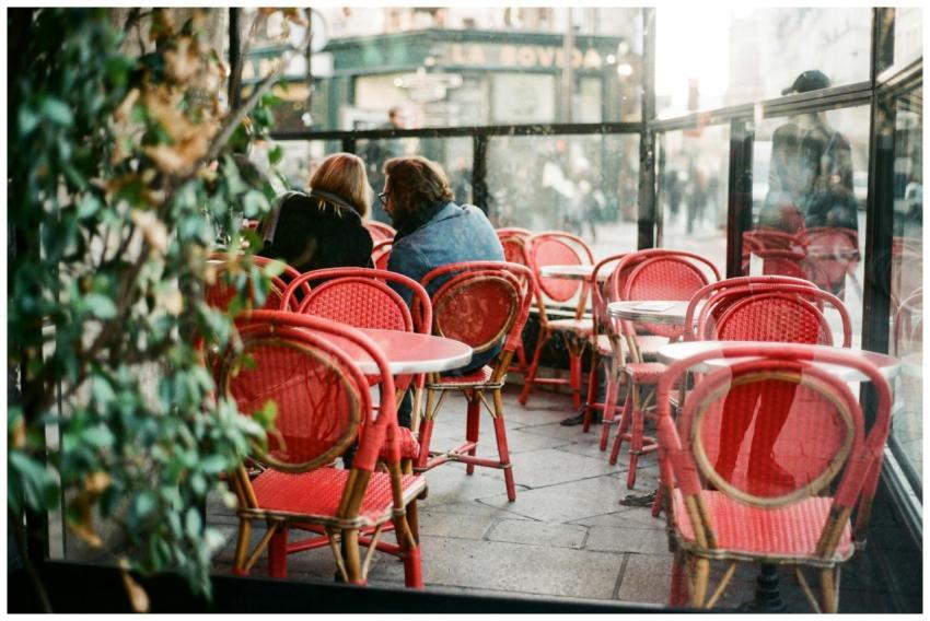 Romantic scene at a Parisian café featuring red ch