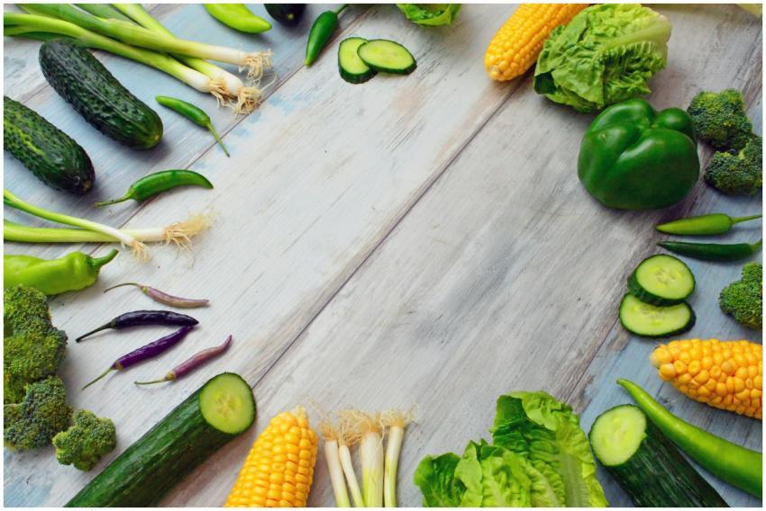 An assortment of fresh vegetables on a wooden tabl