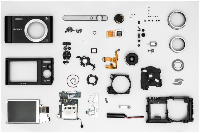 Flat lay of various disassembled camera components