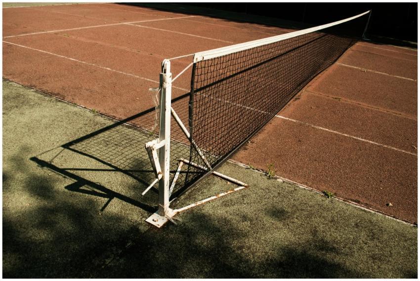 Close-up of a tennis net on a deserted court with