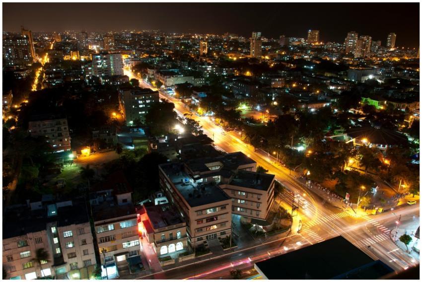 Aerial view of a bustling city at night with vibra