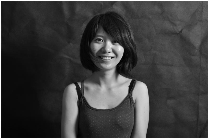 A candid black and white portrait of a young woman