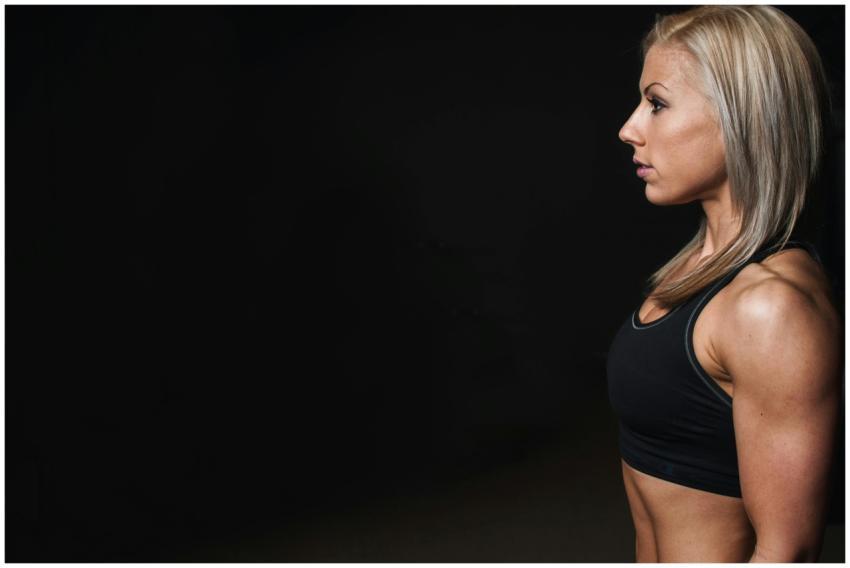 Side profile of a fit female athlete showcasing st