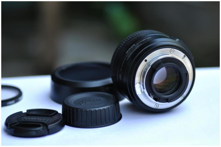 Detailed image of a camera lens with caps and acce