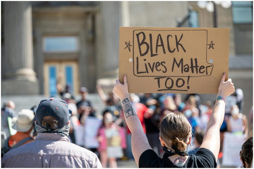 People standing together with cardboard poster dur