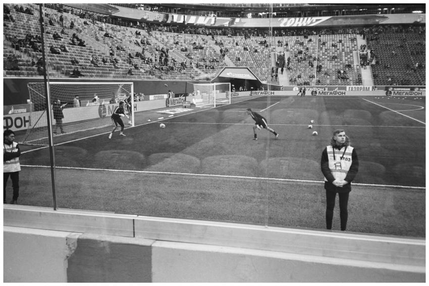Black and white photo capturing a live football ma