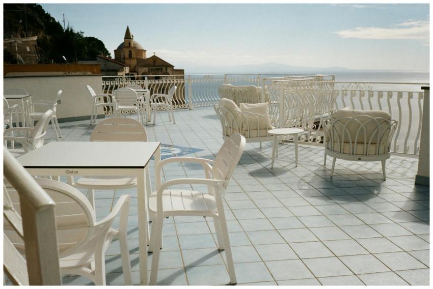 Elegant white patio furniture on a terrace overloo