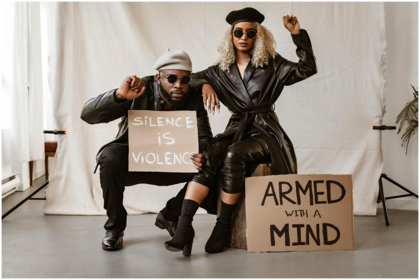 Black couple in studio with protest signs advocati
