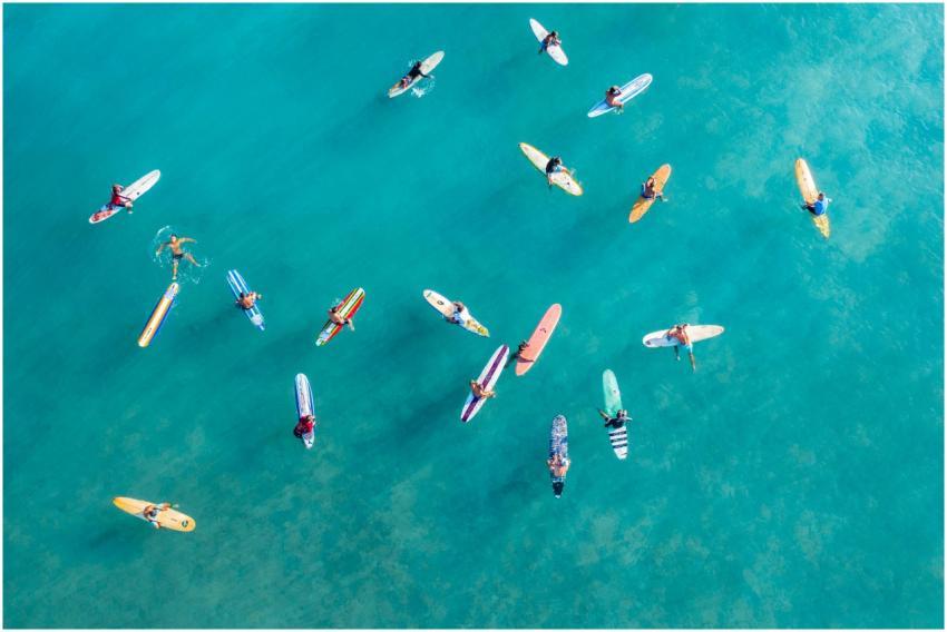 High-angle shot of surfers on colorful surfboards