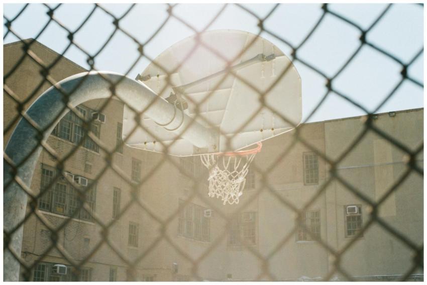 Vintage basketball hoop in urban playground, seen